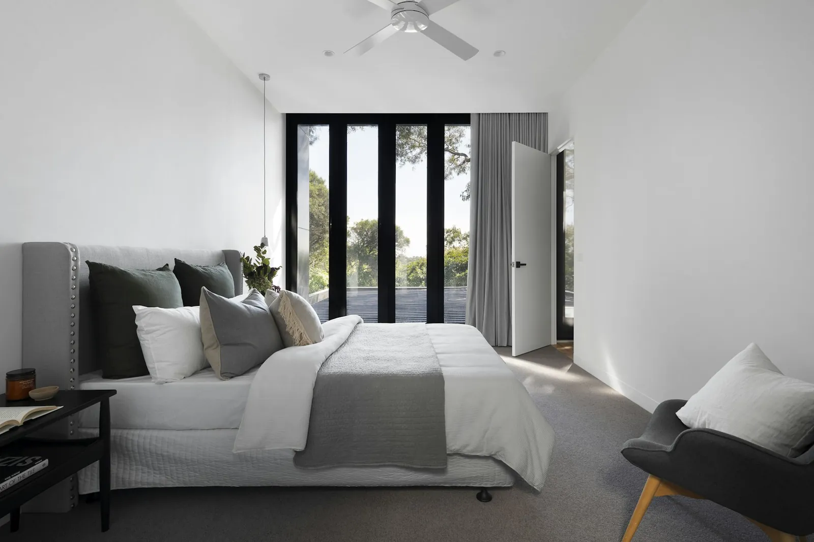 Calm, light bedroom with soft textiles and garden view