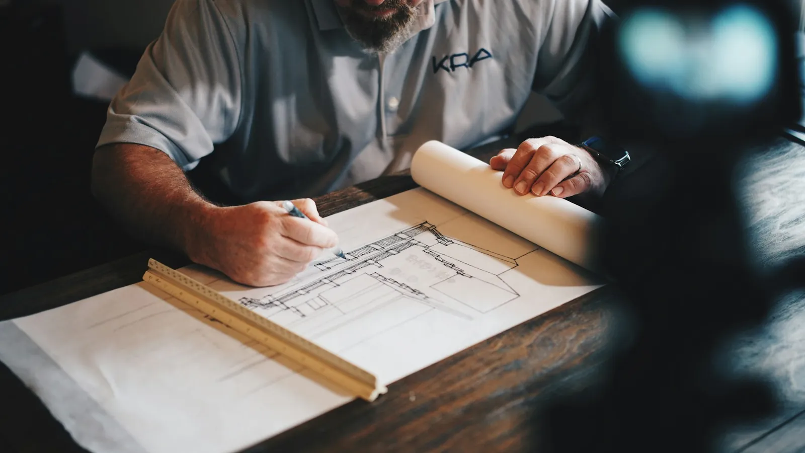 Architect drafting plans on a drawing table