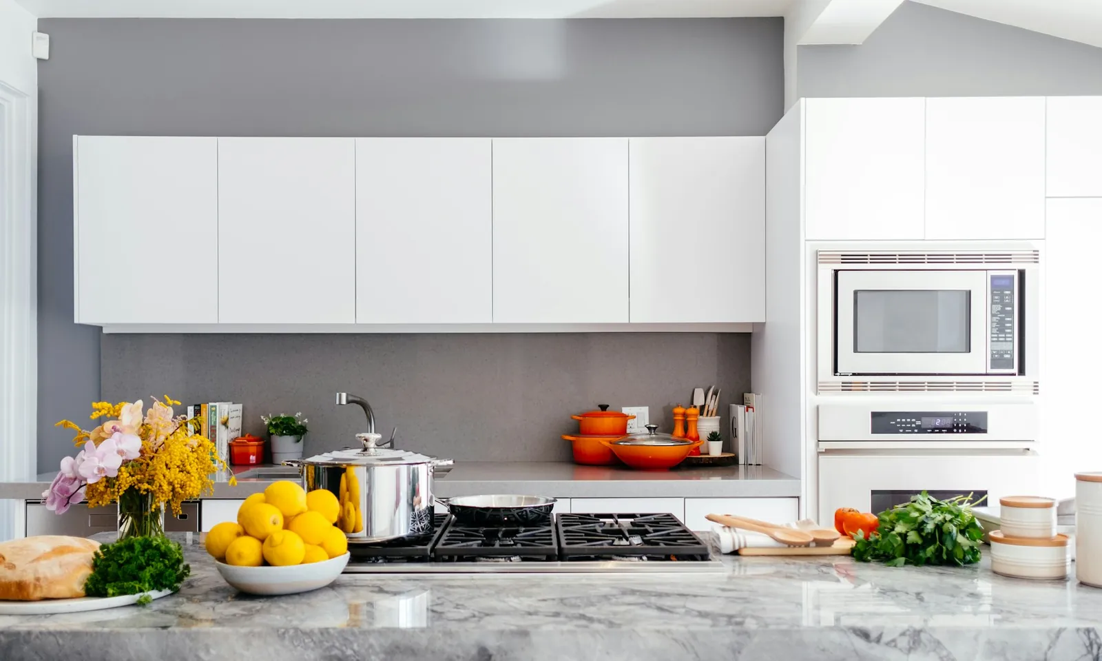 Kitchen with a veined marble island and warm timber cabinetry
