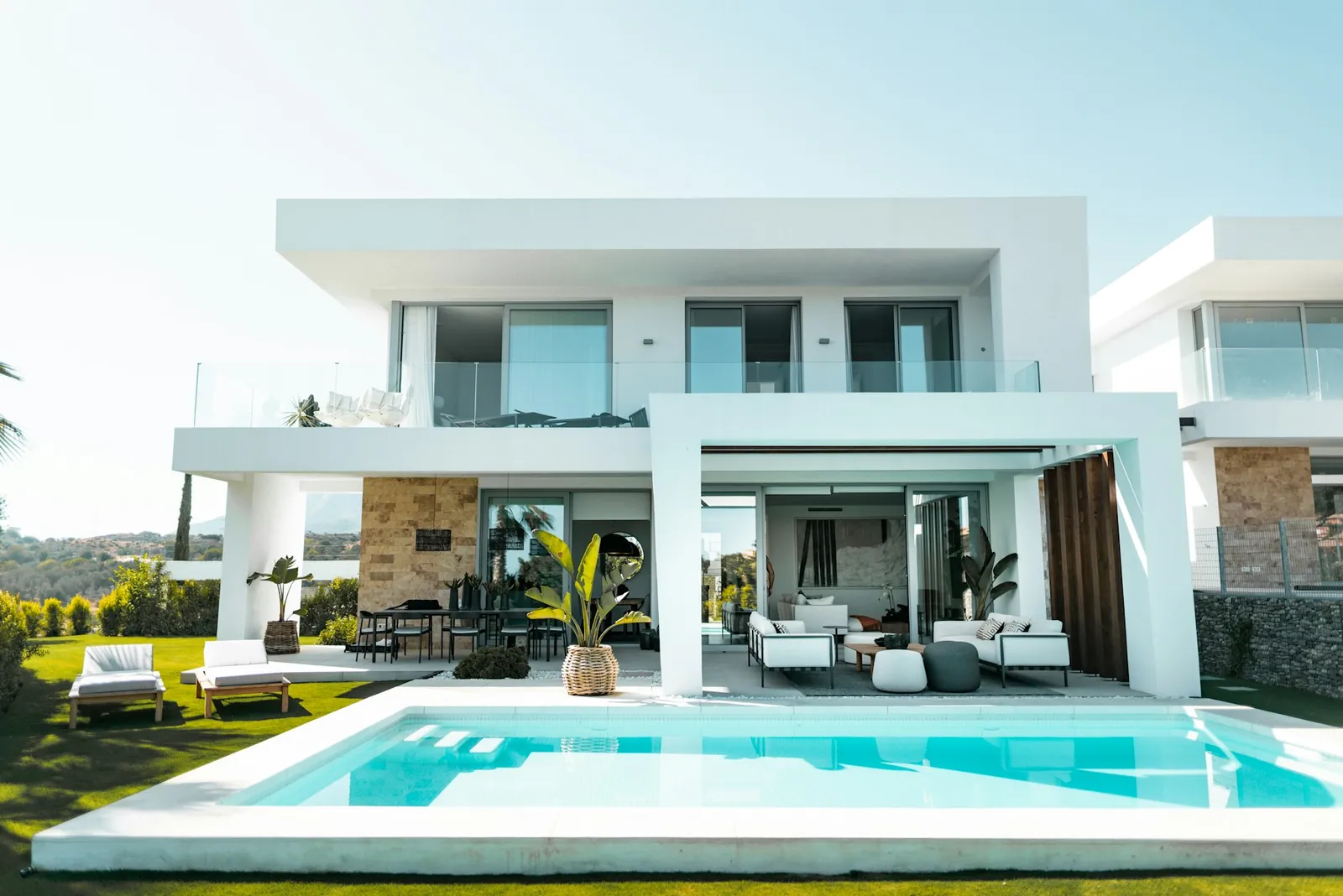 Modern villa façade with balconies and pool