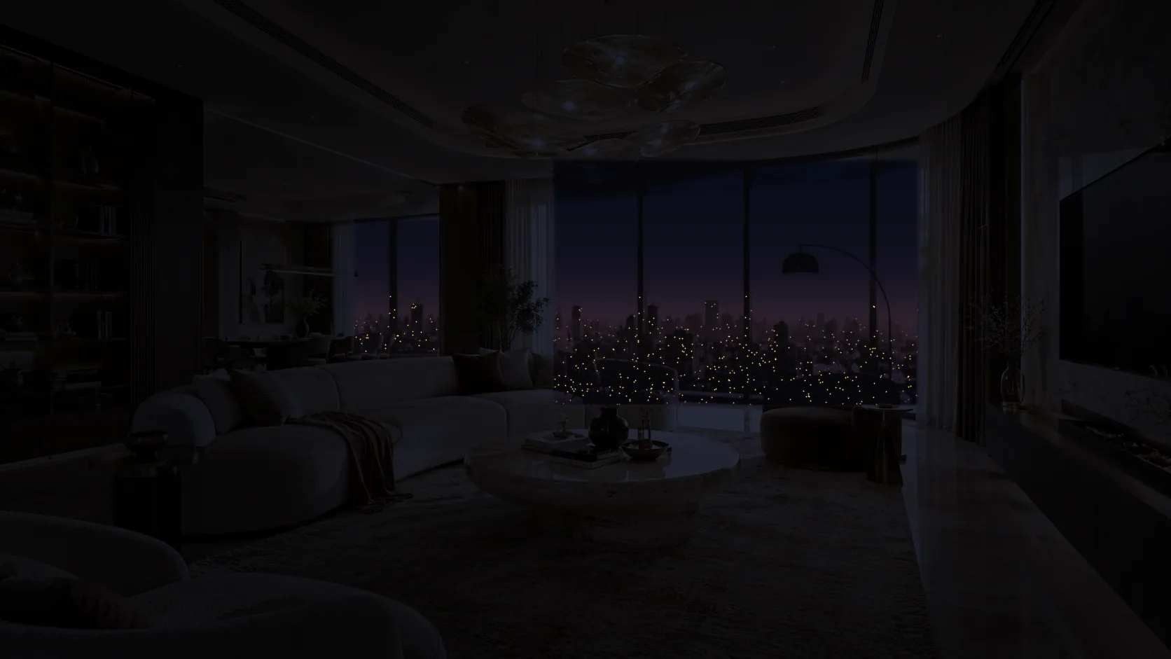 The same living room at night with lights off, lit only by the city